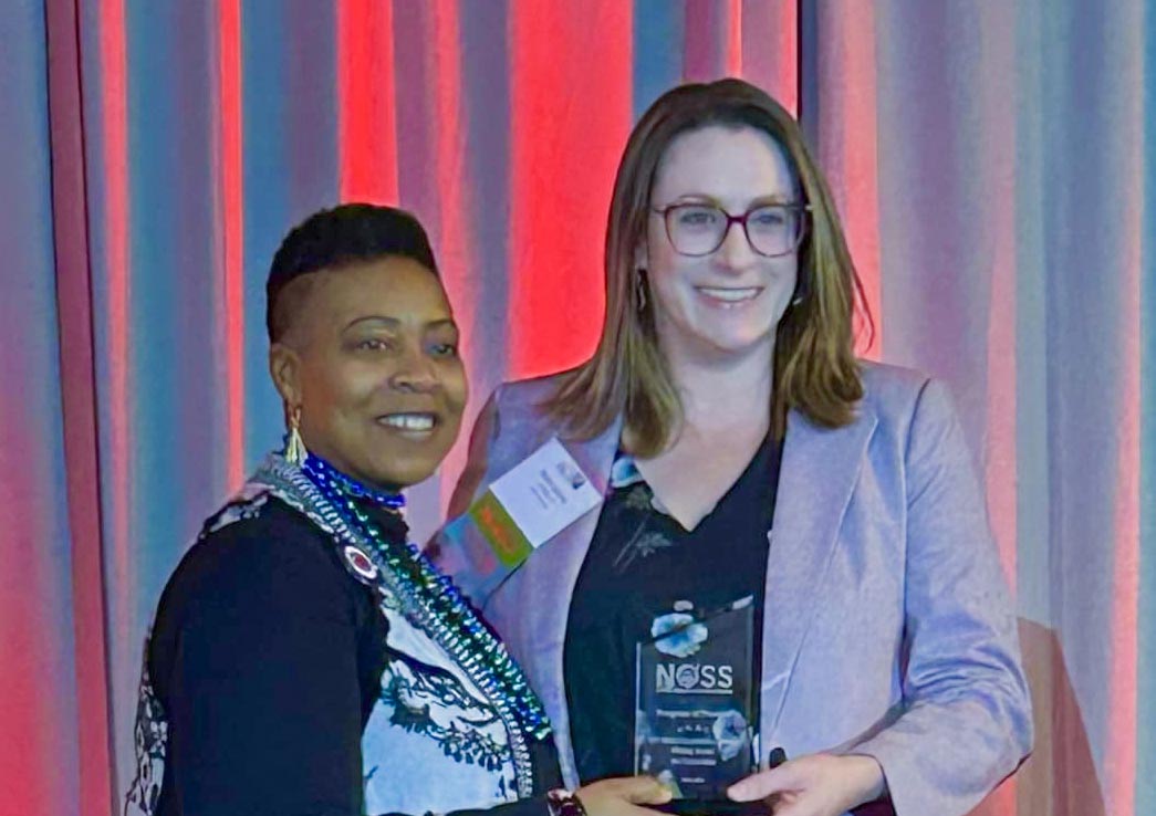 Rachel Jasiczek, Ph.D., CT State's Writing Across the Curriculum program coordinator (right), accepted the award from NOSS President Glynis Mullins on Saturday.
