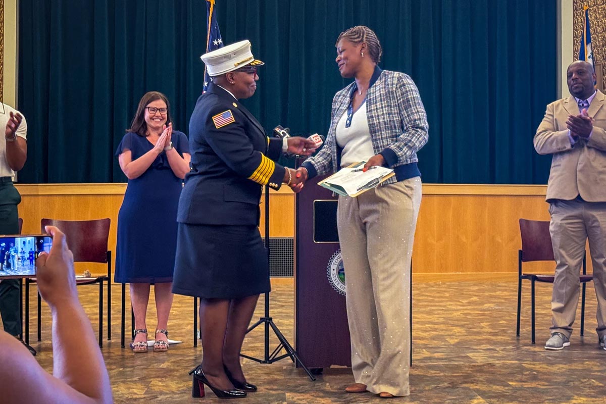 Named as Hamden’s new fire chief, Shelly Carter is congratulated by first Mayor Lauren Garrett (left), Town Clerk Karimah Mickens and Public Safety Chair Adrian Webber (right). (Macy Hanzlik-Barend/Connecticut Public)