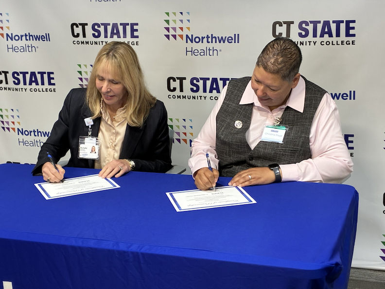 Michelle Robertson, market president (Northeast Region) Northwell Health, and CT State College Interim President Christina Royal sign the partnership agreement between the two entities on Monday. Photo by Gary Larkin