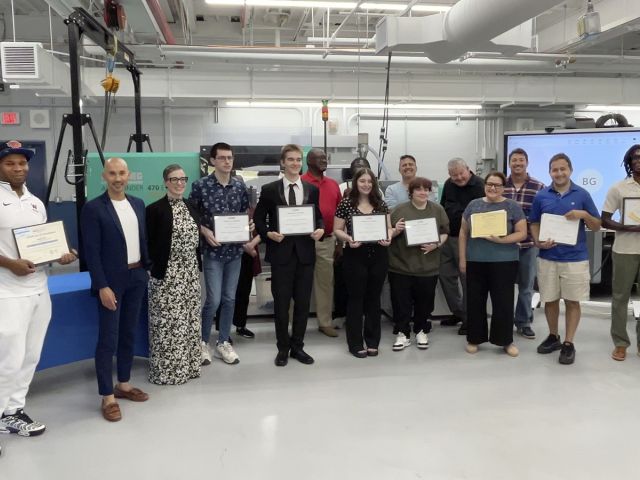 Students cpictured holding awards for completion of Skill Up for Manufacturing training program