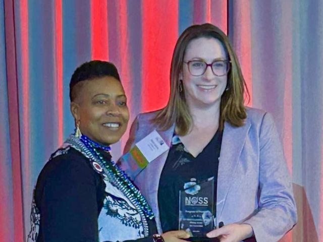 Rachel Jasiczek, Ph.D., CT State's Writing Across the Curriculum program coordinator (right), accepted the award from NOSS President Glynis Mullins on Saturday.