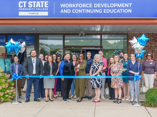 Officials and staff cut a ceremonial ribbon at CT State Tunxis's workforce training expansion in Bristol