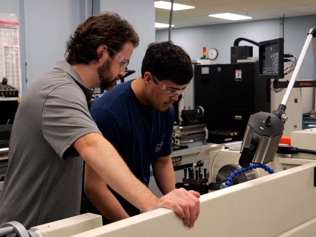 Student working with manufacturing equipment in a CT State lab