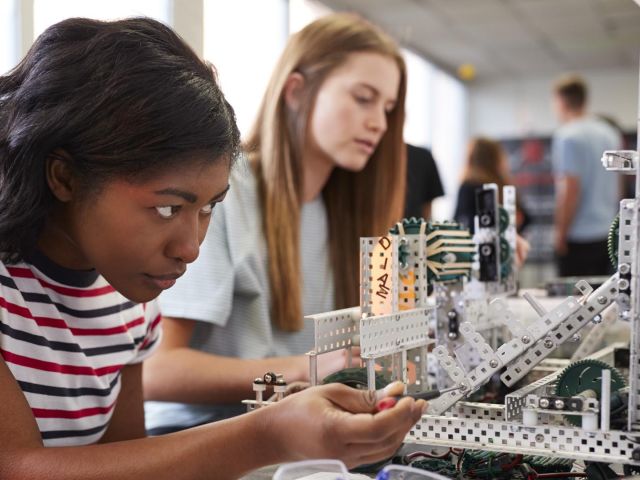 Two students building a robotics project in a STEM lab
