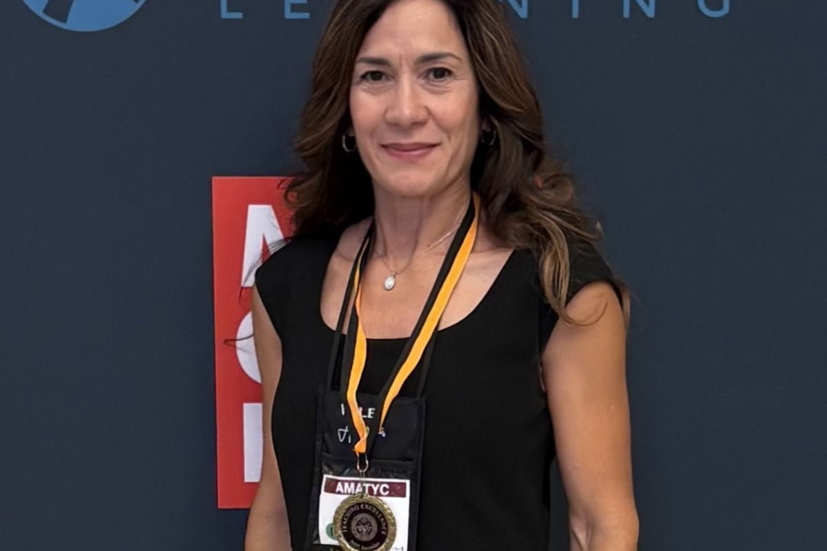 Marta smiles wearing her award