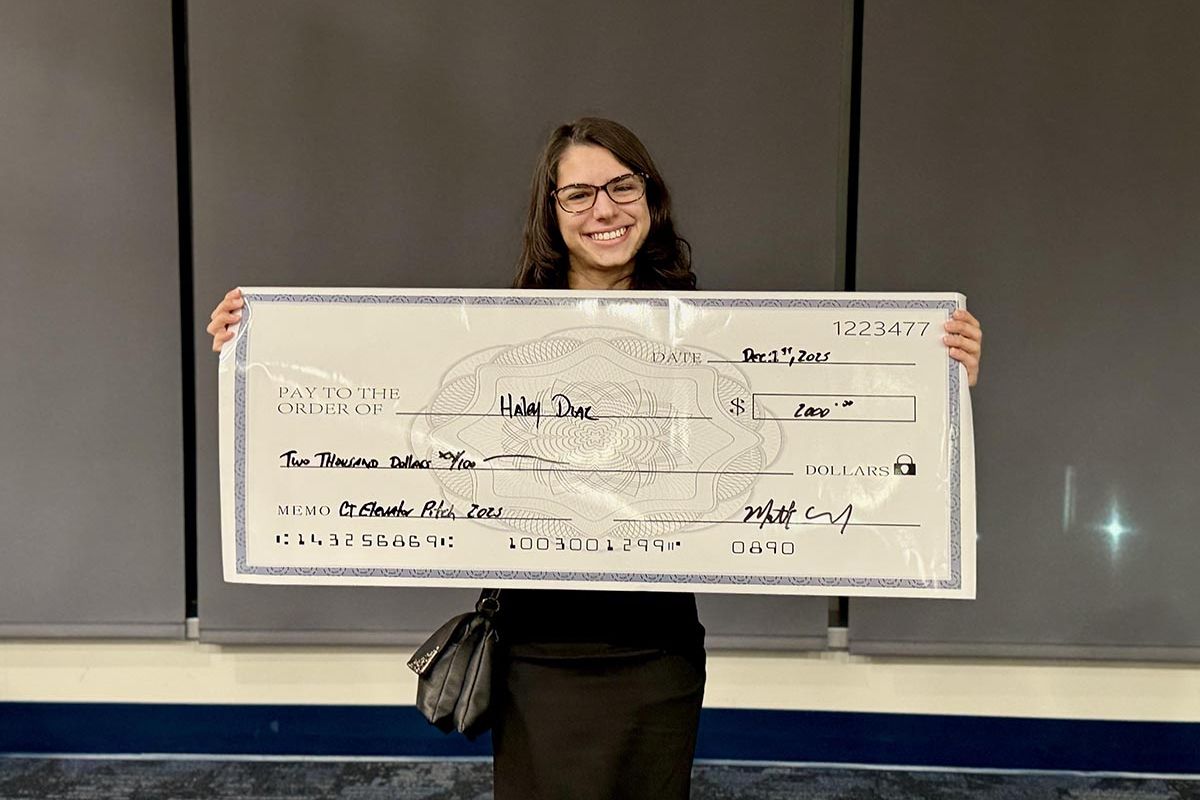 Student Hailey Diaz is holding a replica of the prize.