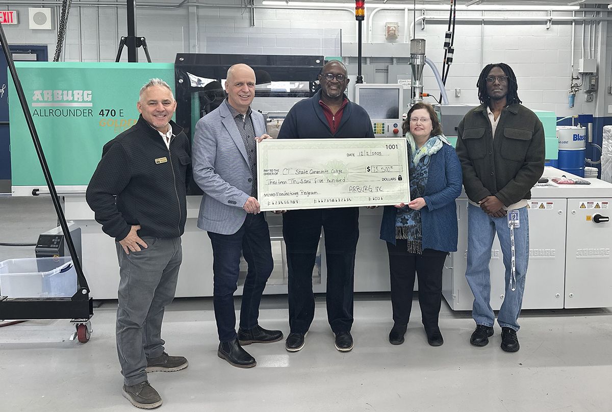 Five people hold a replica of a $13,500 check