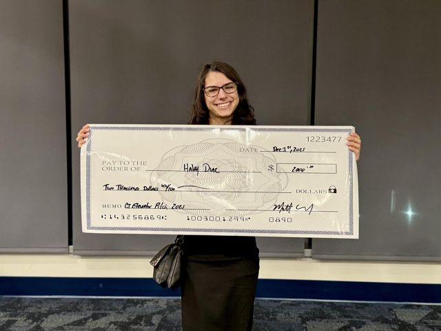 Student Hailey Diaz is holding a replica of the prize.