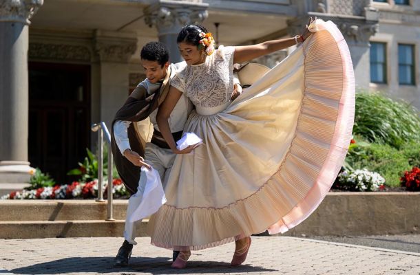 Emmy Gallegos dances with instructor Carlos Gallardo celebrating Peru's independence day at the state capitol in 2024