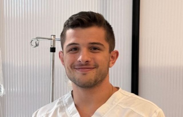 smiling man in nurses uniform