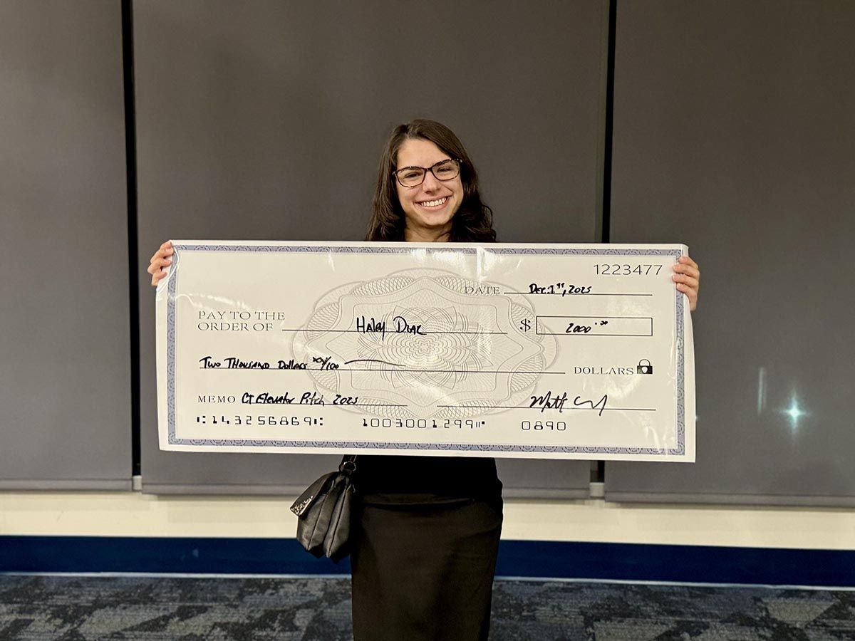 Student Hailey Diaz is holding a replica of the prize.