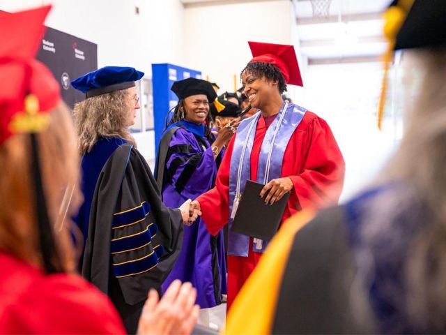 Graduates celebrated during a joint CT State Community College and Wesleyan University commencement ceremony in May at York Correctional Institution