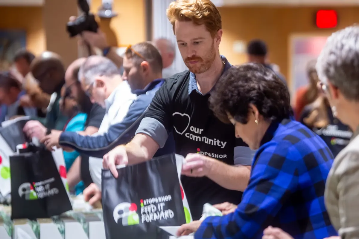 Students distribute fresh produce at CT State campus food insecurity event.