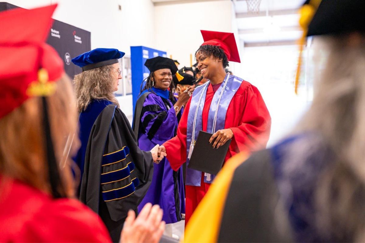 Graduates celebrated during a joint CT State Community College and Wesleyan University commencement ceremony in May at York Correctional Institution