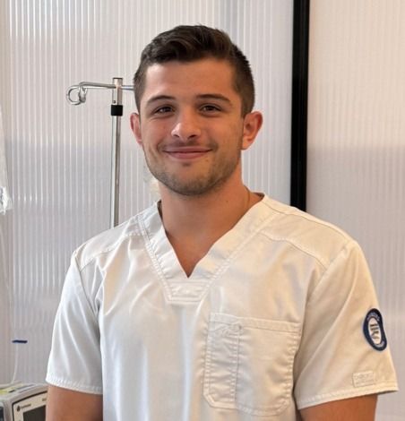 smiling man in nurses uniform