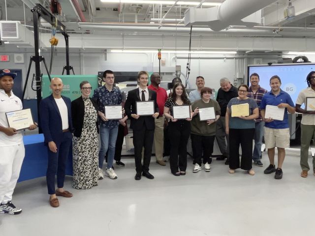 Students cpictured holding awards for completion of Skill Up for Manufacturing training program
