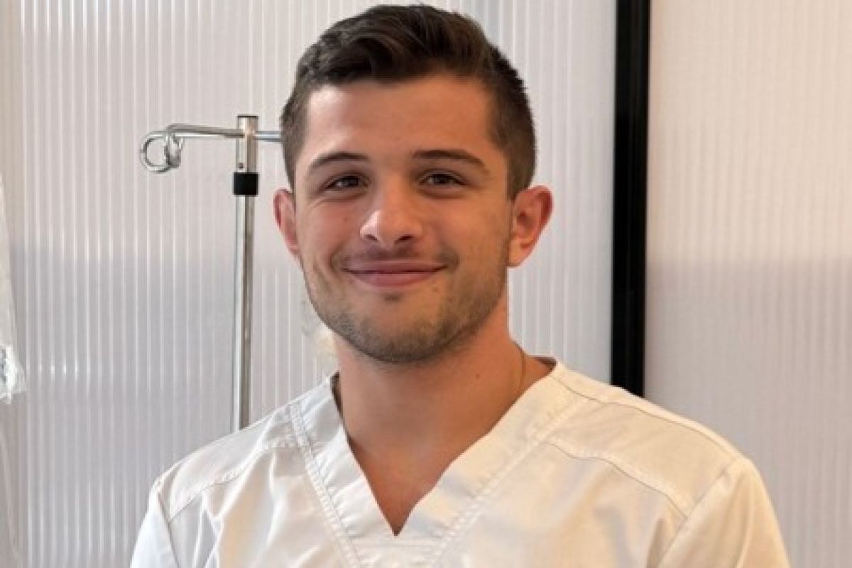 smiling man in nurses uniform
