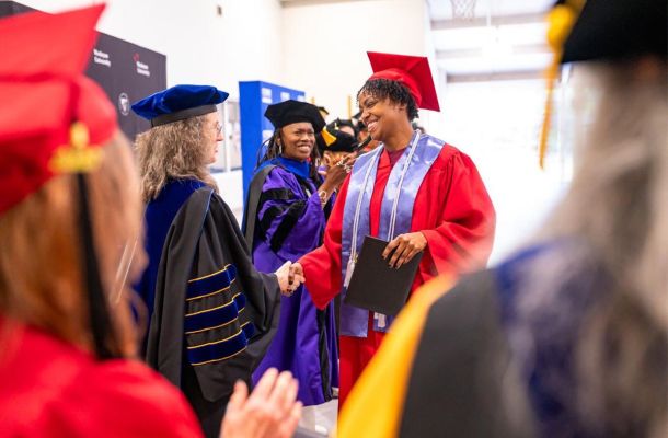 Graduates celebrate during a joint CT State Community College and Wesleyan University commencement ceremony in May at York Correctional Institutio