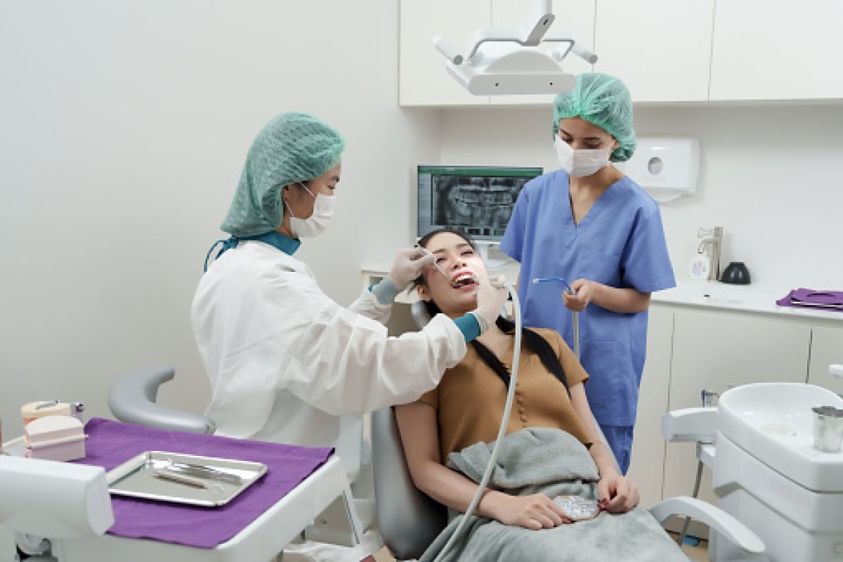 Students participate in a hands-on healthcare training activity in a clinical learning environment at CT State Community College.