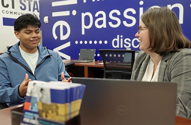 A student discusses registration with a CT State worker.